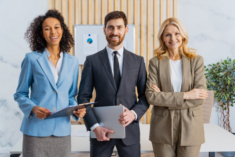Group of multiethnic businesspeople standing at computer desk in